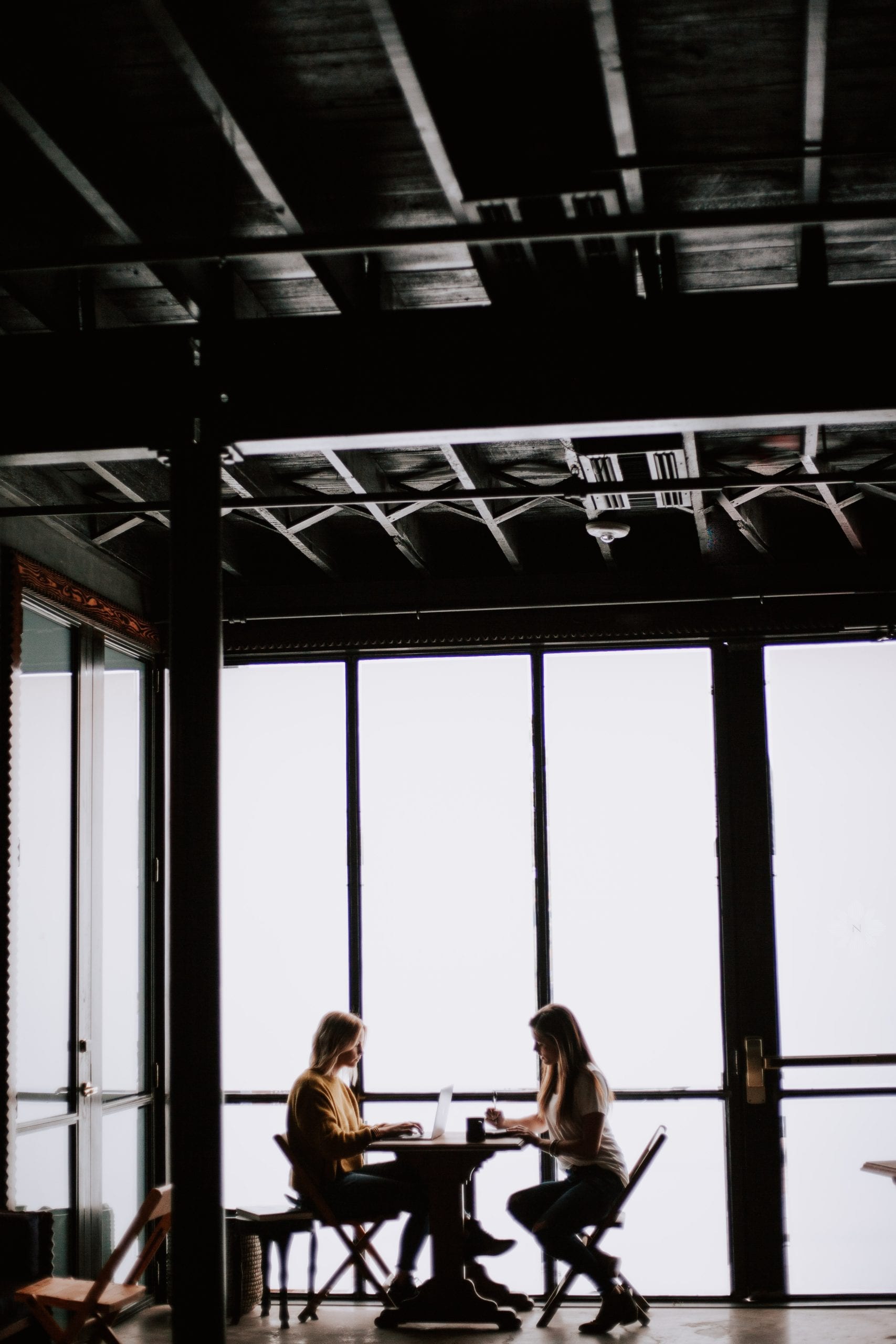 Two ladies meeting across table | example of Healthcare Advocate